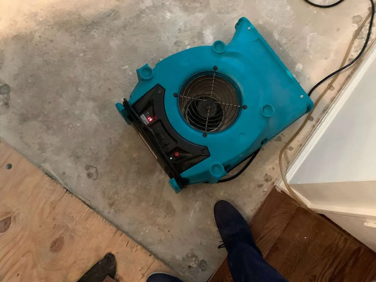 Air mover drying subfloor during Leak Detection & Repair in Waldoboro